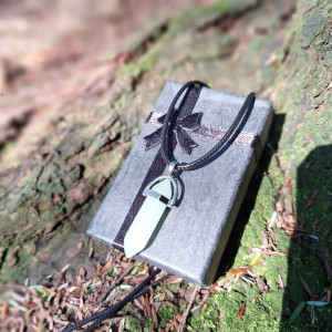 Milky white quartz crystal point necklace displayed on gift box