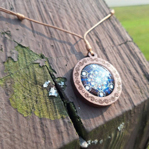 Wood-framed Metatron's Cube dome pendant necklace on adjustable brown cord